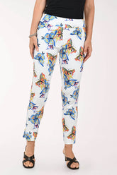 Person wearing colorful butterfly-patterned pants on a white background