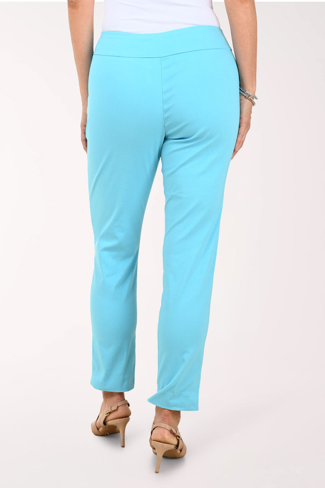 Person wearing turquoise pants on a white background