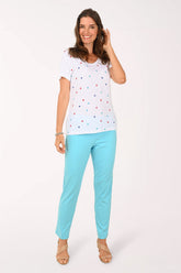 Person wearing turquoise pants on a white background