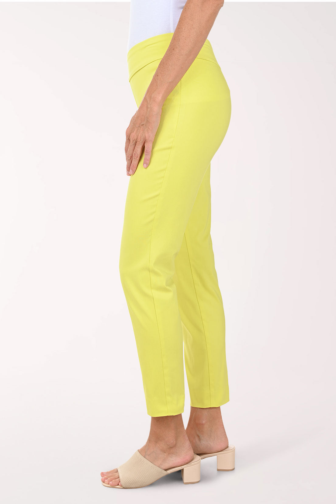 Person wearing bright yellow pants on a white background