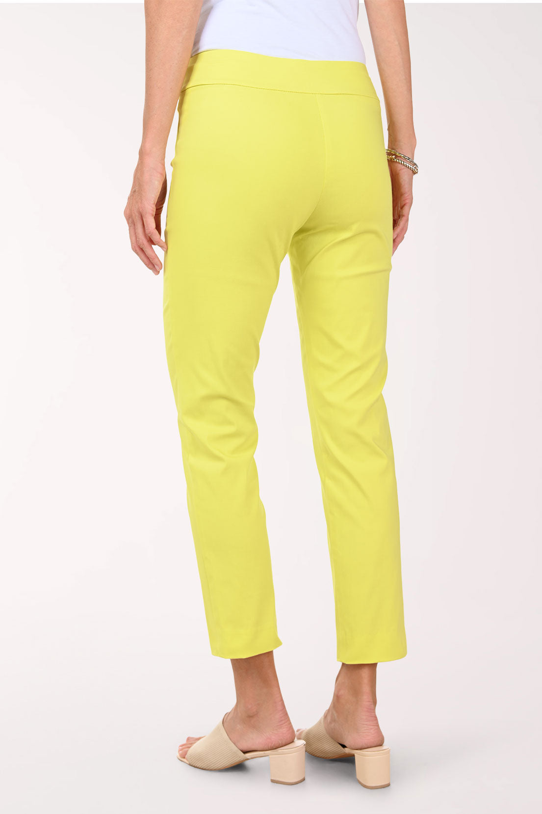 Person wearing bright yellow pants on a white background