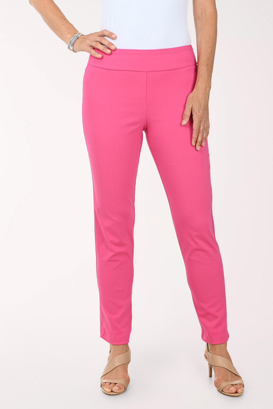 Person wearing bright pink pants on a white background