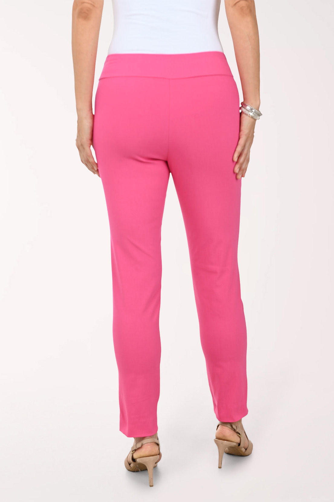 Person wearing bright pink pants on a white background