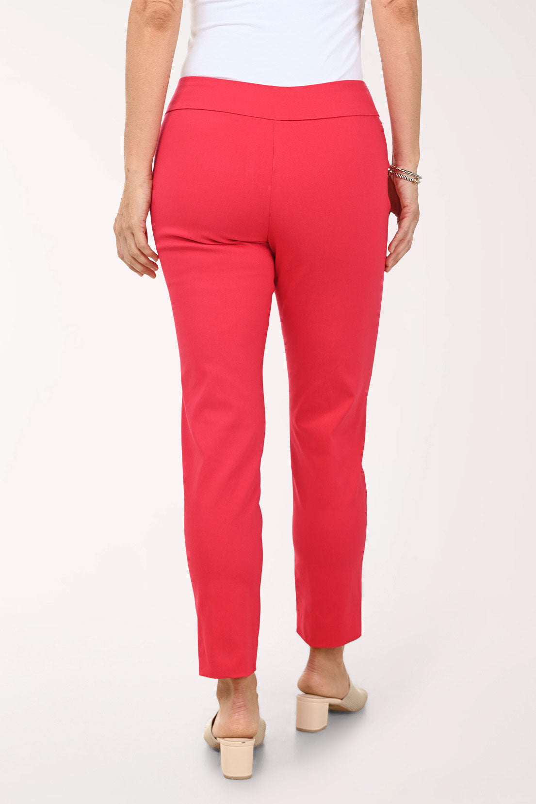 Red pants worn by a person on a white background