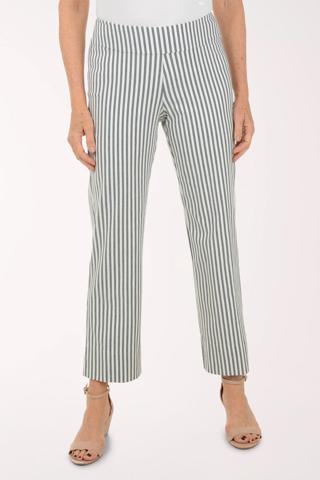 Person wearing green and white striped pants on a white background