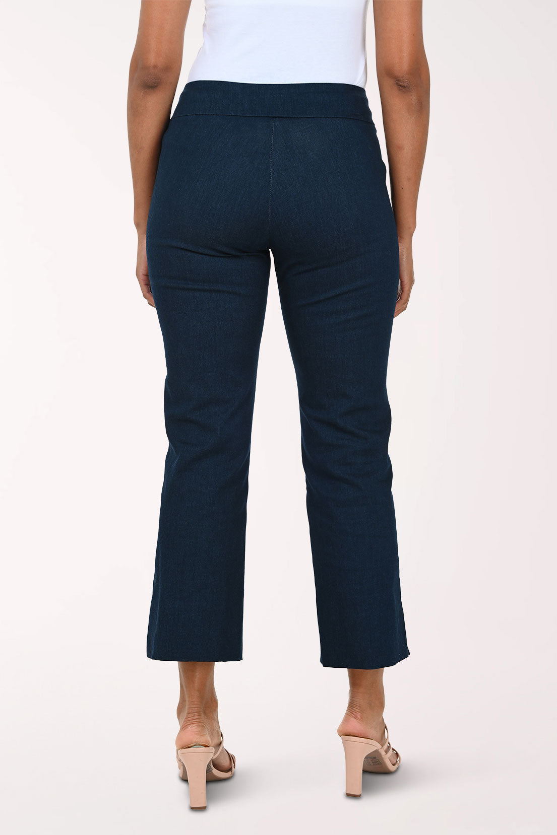 Denim blue pants worn by a person on a white background