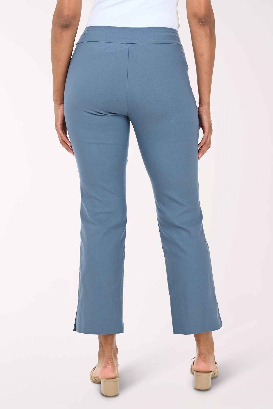 Blue pants worn by a person on a white background