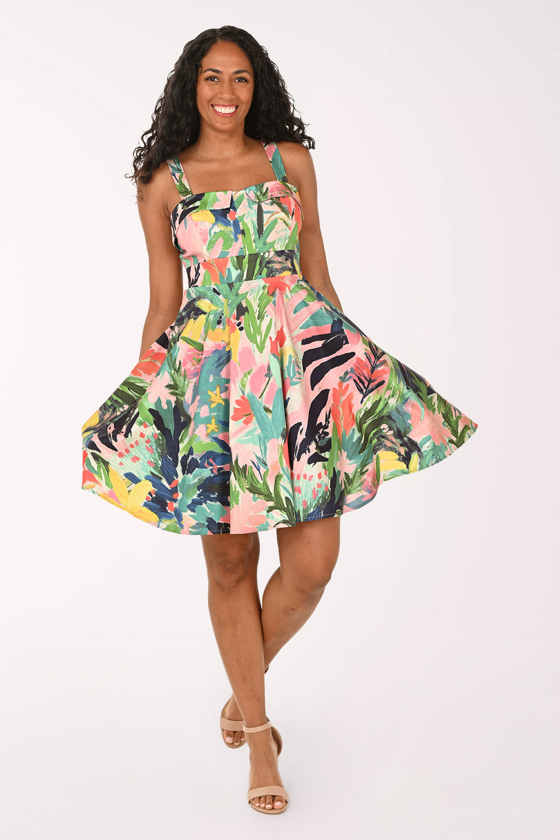 Woman wearing a colorful floral dress on a white background