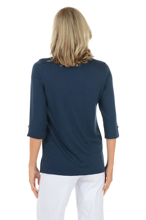 Woman wearing a navy blue top with rolled-up sleeves on a white background. Back shot.