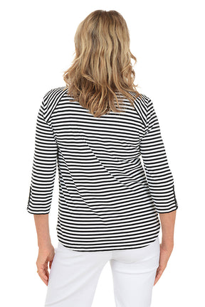Woman wearing a black and white striped shirt on a white background. Back shot.