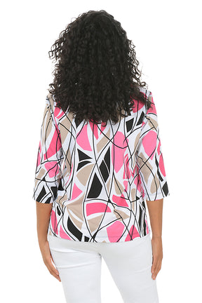 Woman wearing a colorful abstract patterned top and white pants on a white background. Back shot.