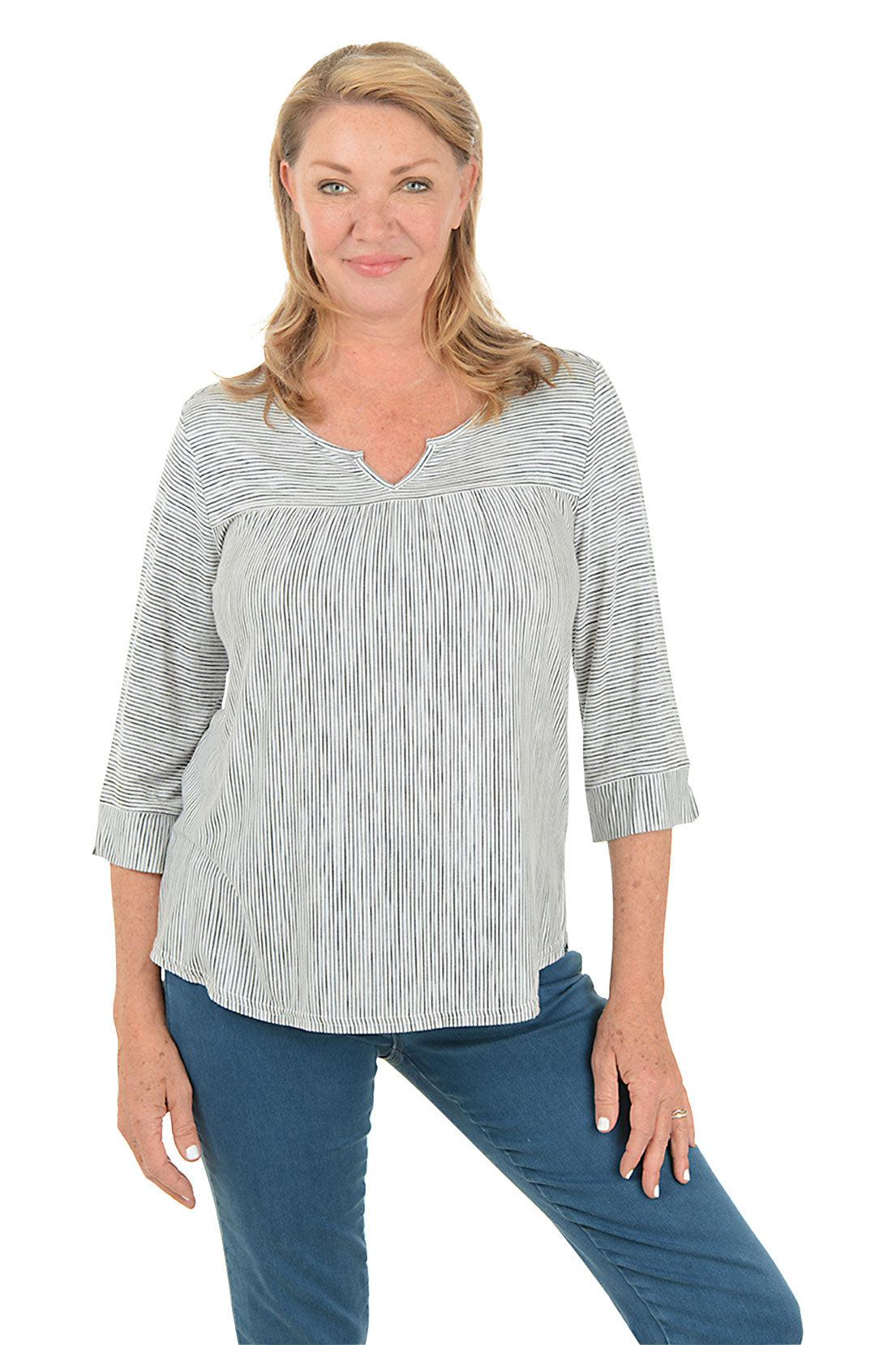 Woman wearing a striped blouse and blue jeans on a white background.