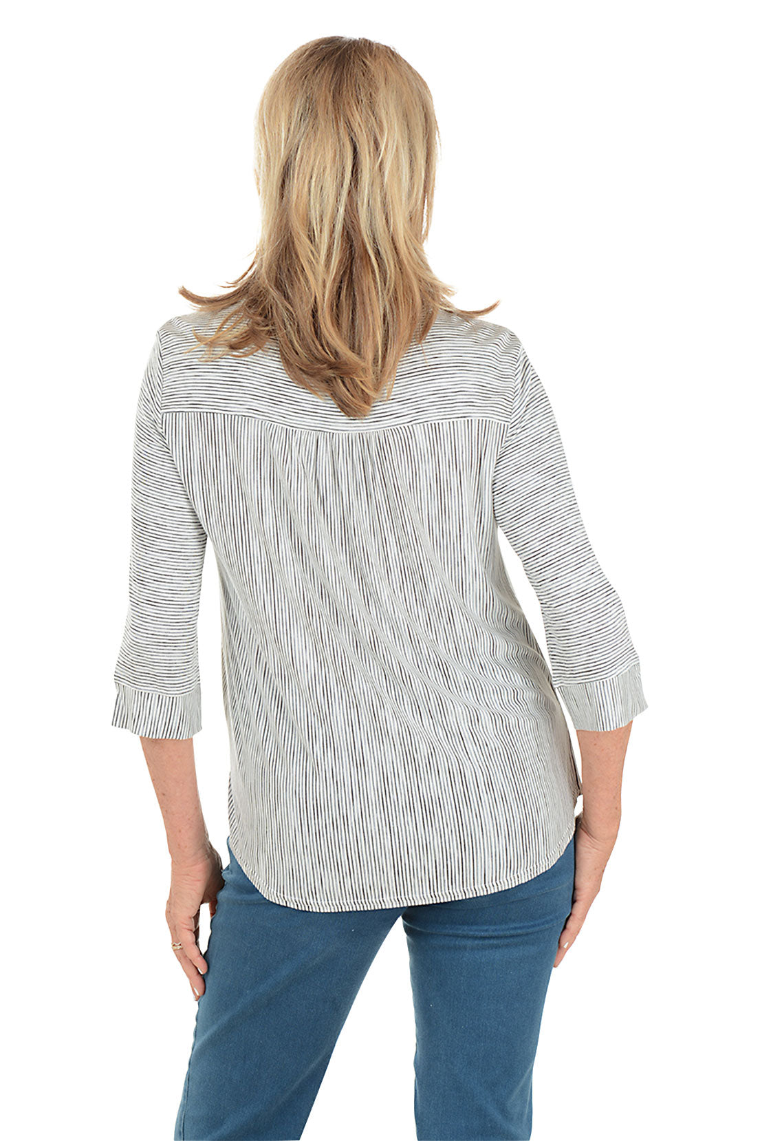 Woman wearing a striped blouse and blue jeans on a white background. Back shot.