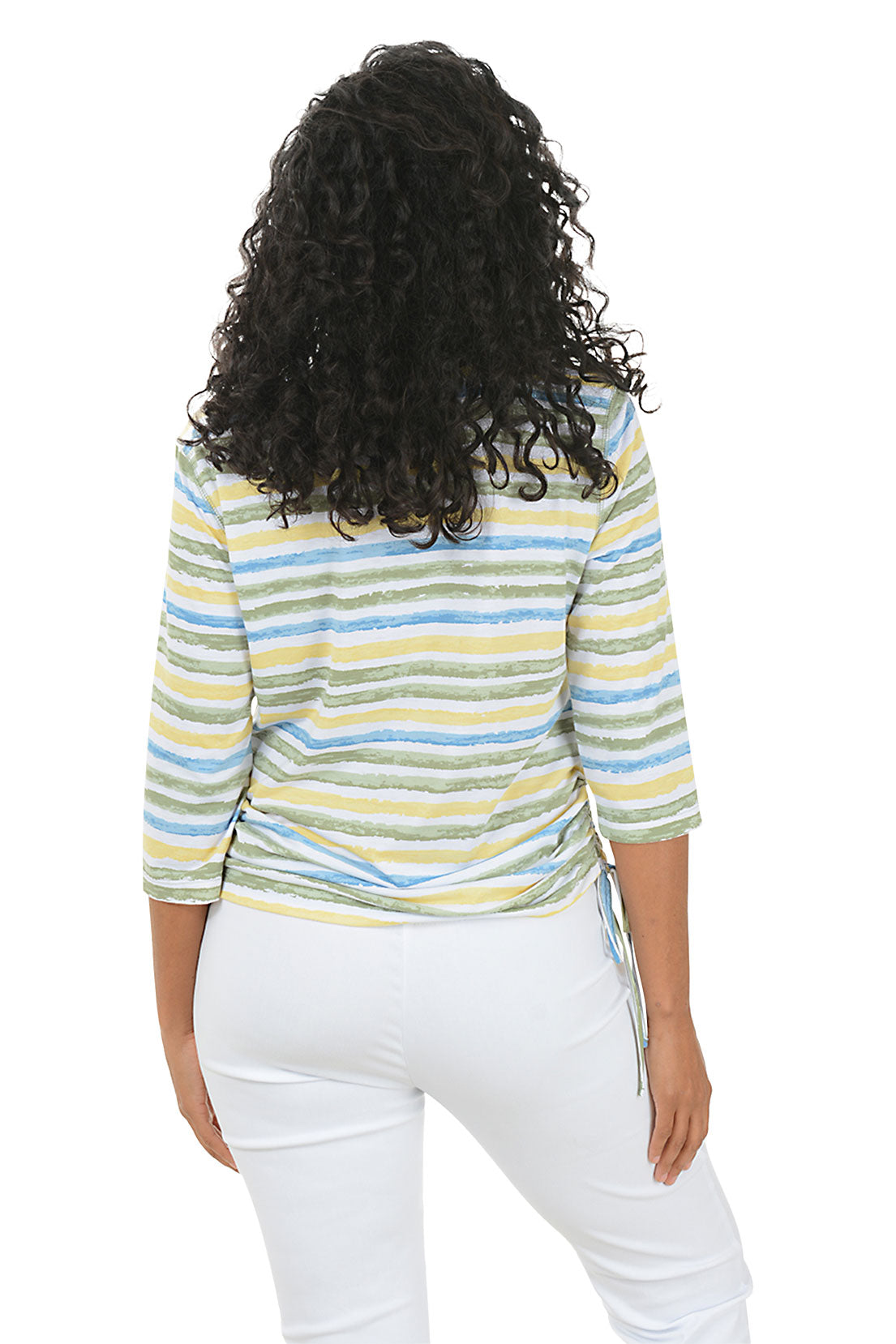 Woman wearing a striped long-sleeve top and white pants on a white background. Back shot.