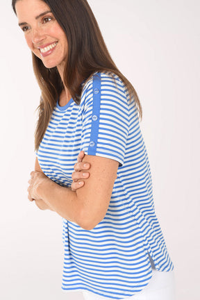 Woman wearing a blue and white striped shirt with suspenders on a white background
