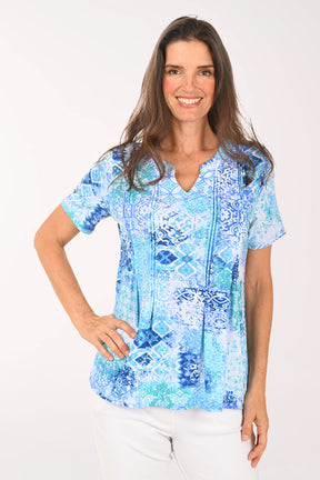 Woman wearing a short sleeve blue top.