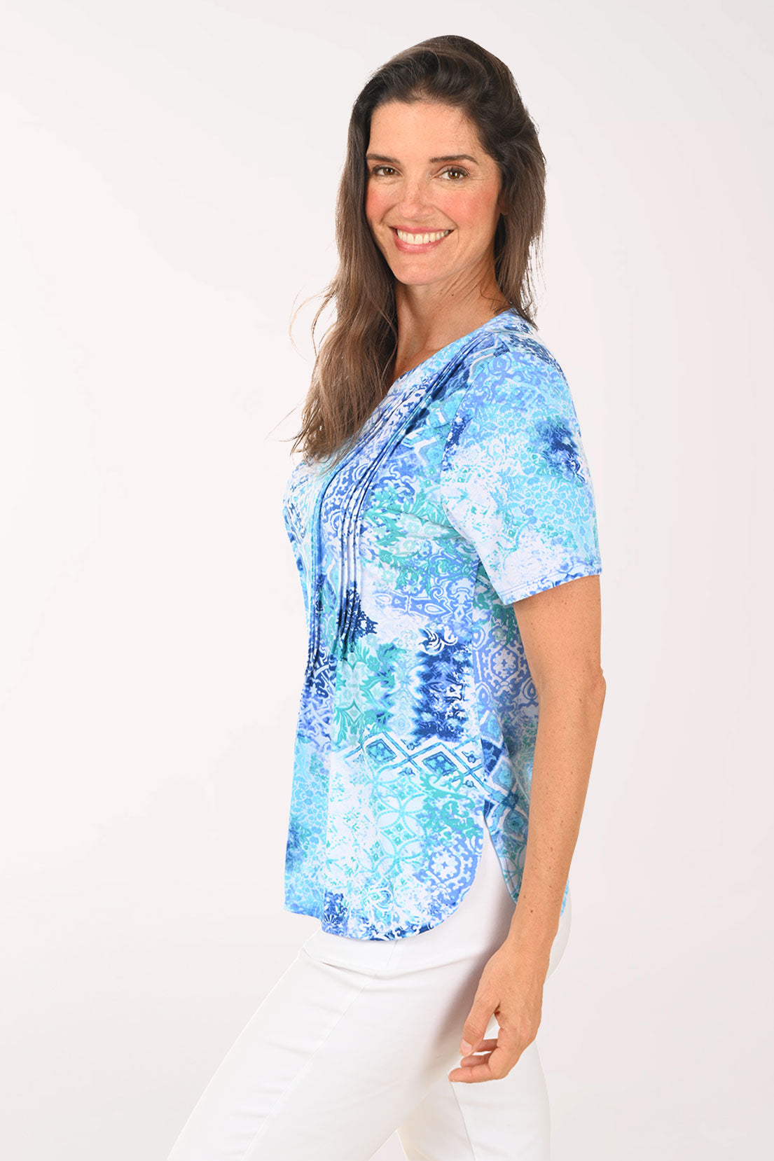 Woman wearing a short sleeve blue top.