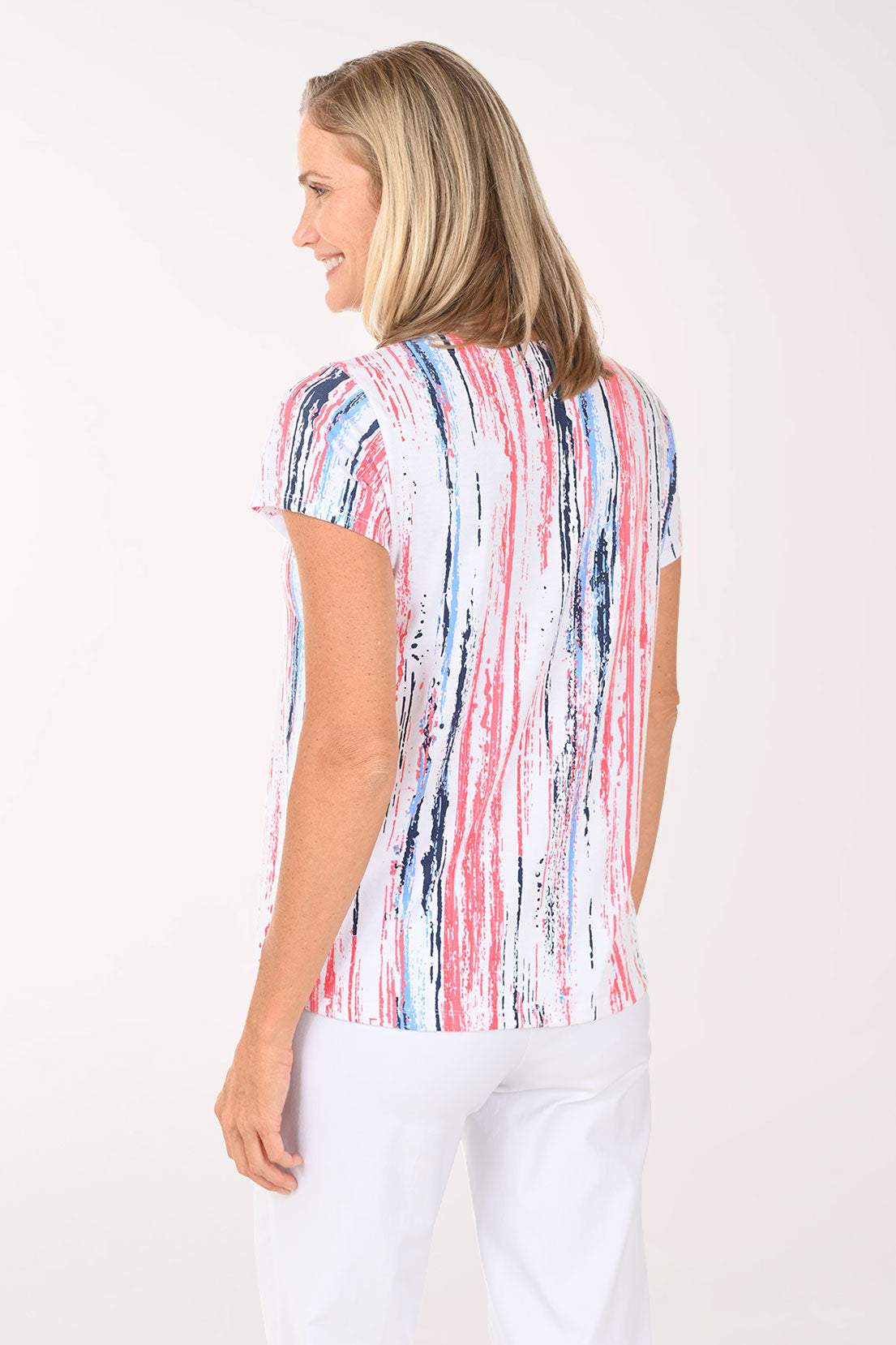 Woman wearing a colorful striped shirt on a white background