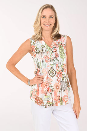 Woman wearing a floral pink sleeveless top.