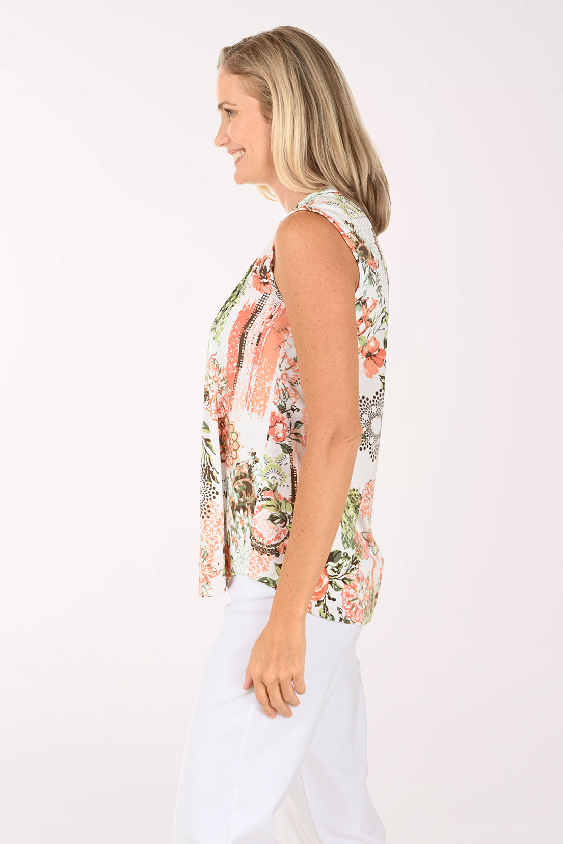 Woman wearing a floral pink sleeveless top.
