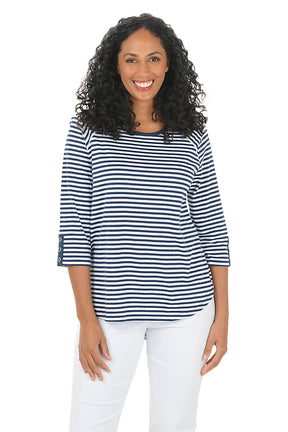 Woman wearing a striped shirt and white pants on a white background