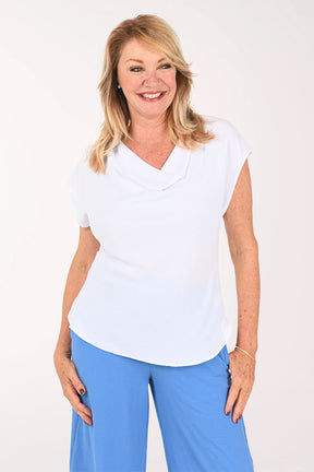 Woman wearing a white cap sleeve tee with a draped neckline