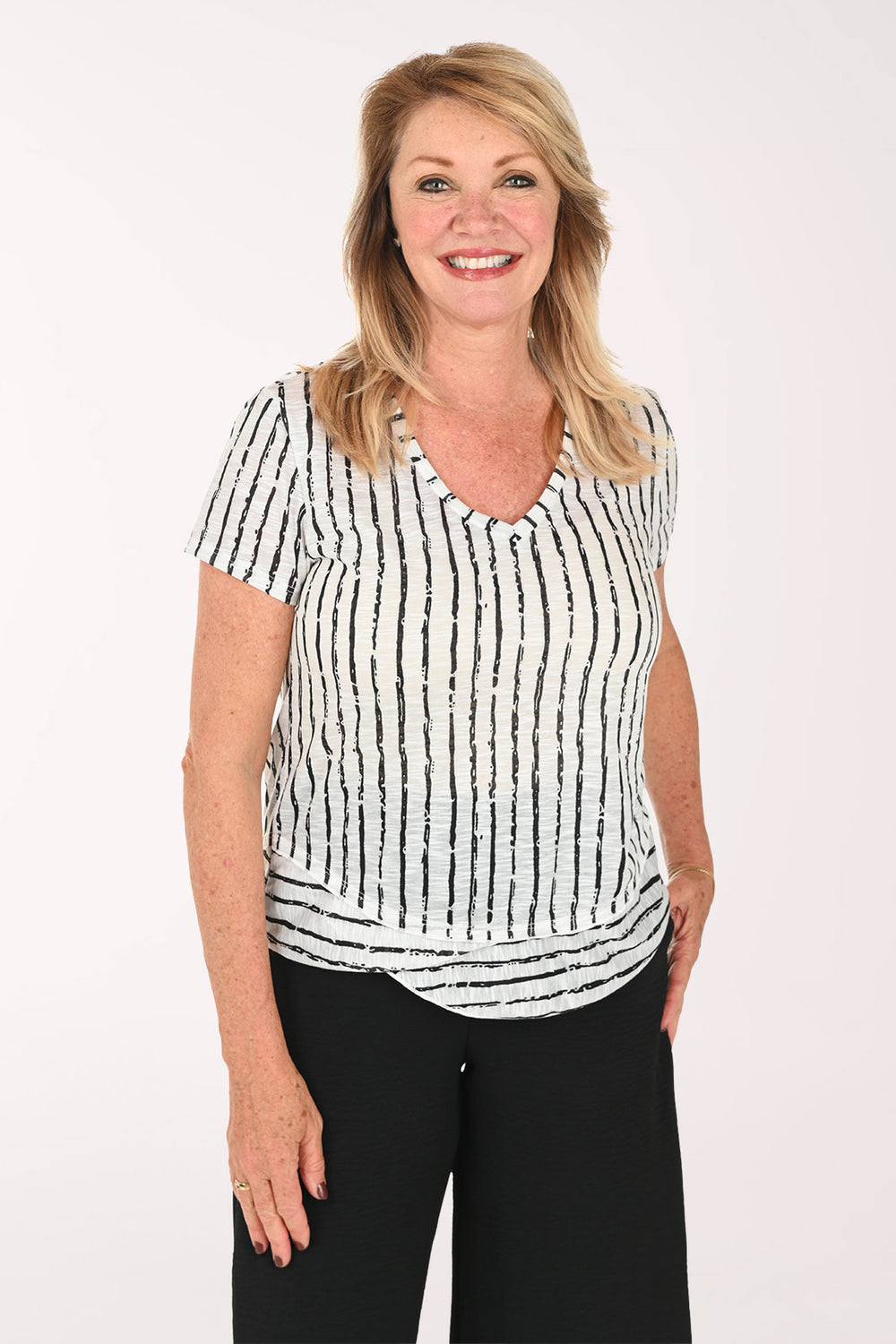 Woman wearing a black and white striped short sleeve tee