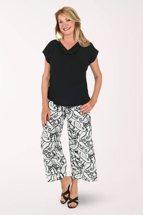 Woman wearing black and white paisley cropped bottoms