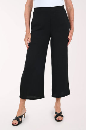 Woman wearing black flared crop pants