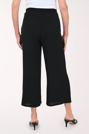 Woman wearing black flared crop pants