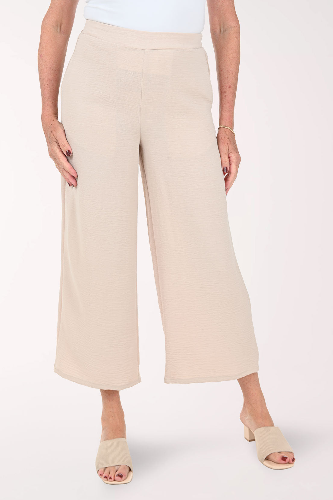 Woman wearing beige flared crop pants