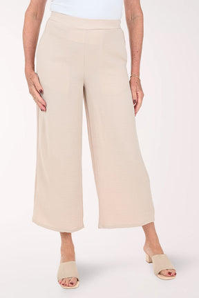 Woman wearing beige flared crop pants