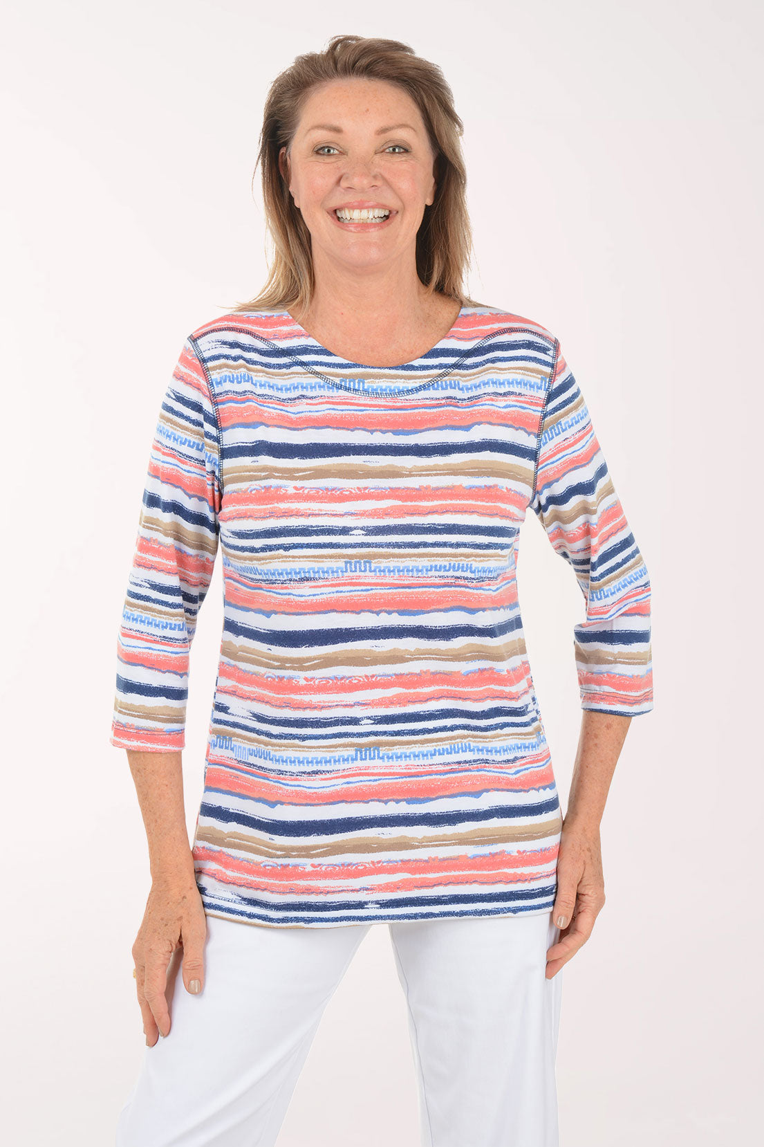 Woman wearing a colorful striped sweater on a white background