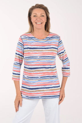 Woman wearing a colorful striped sweater on a white background