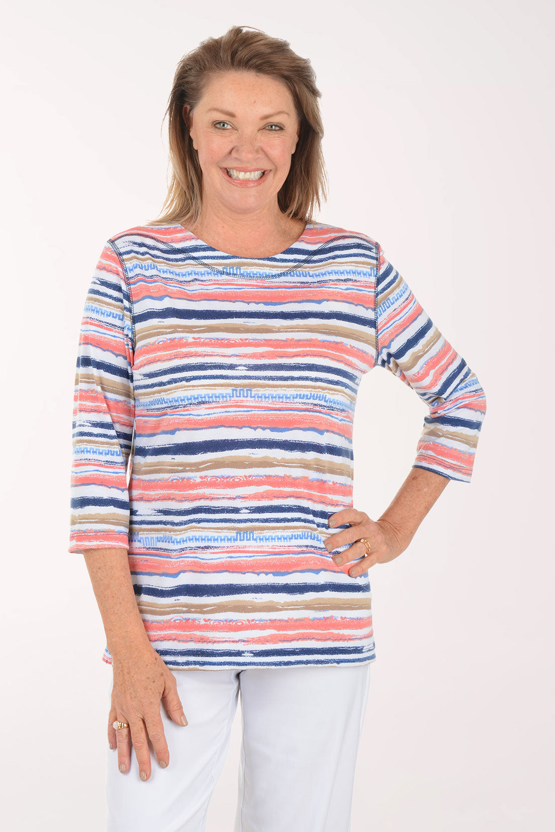Woman wearing a colorful striped sweater on a white background