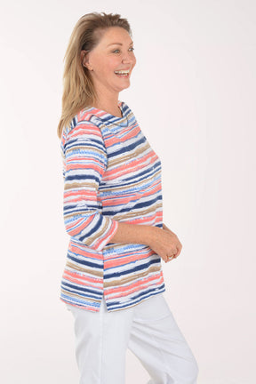 Woman wearing a colorful striped sweater on a white background