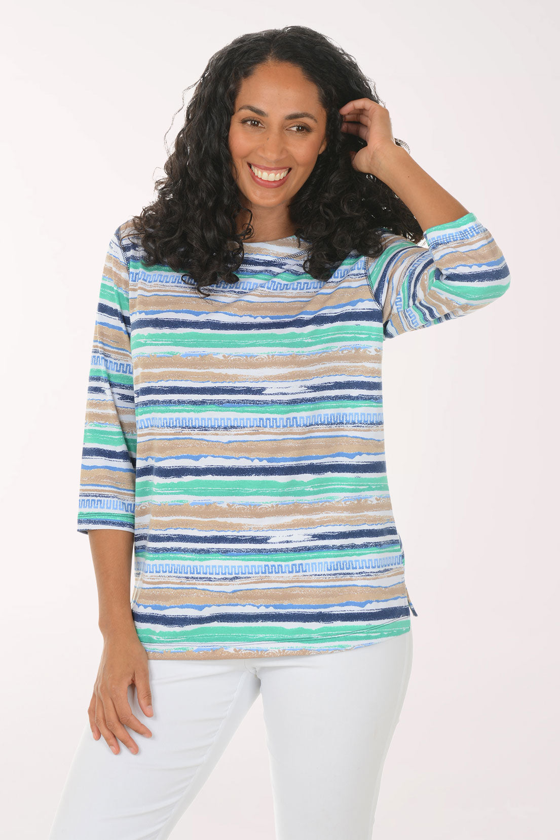 Woman wearing a colorful striped sweater on a white background