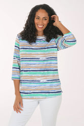 Woman wearing a colorful striped sweater on a white background