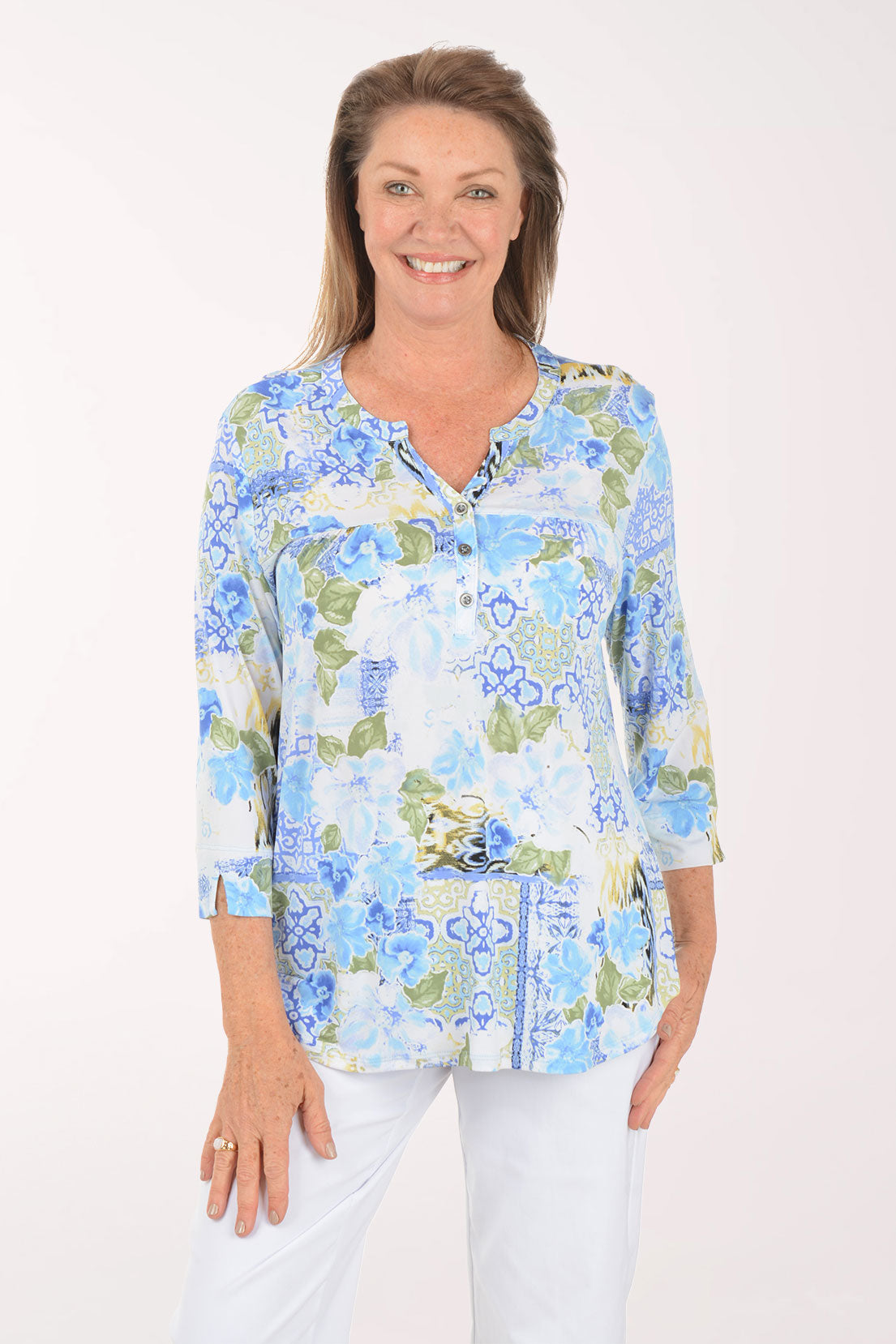 Woman wearing a floral blouse with a white background