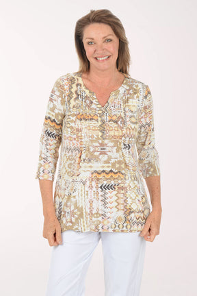 Woman wearing a patterned blouse with a plain background