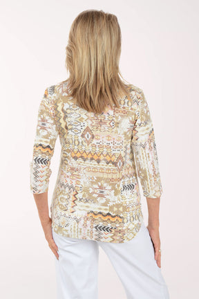 Woman wearing a patterned blouse with a plain background