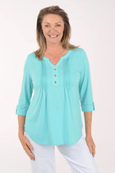 Woman wearing a light blue blouse with a white background