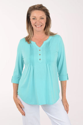Woman wearing a light blue blouse with a white background