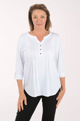Woman wearing a white blouse with buttons on a white background