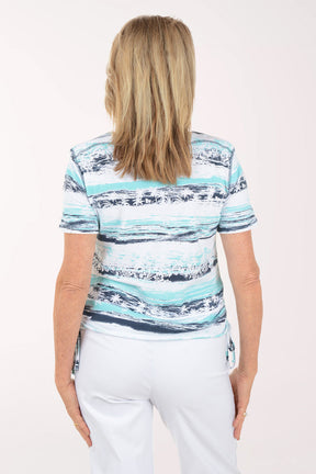 Woman wearing a colorful striped shirt on a white background