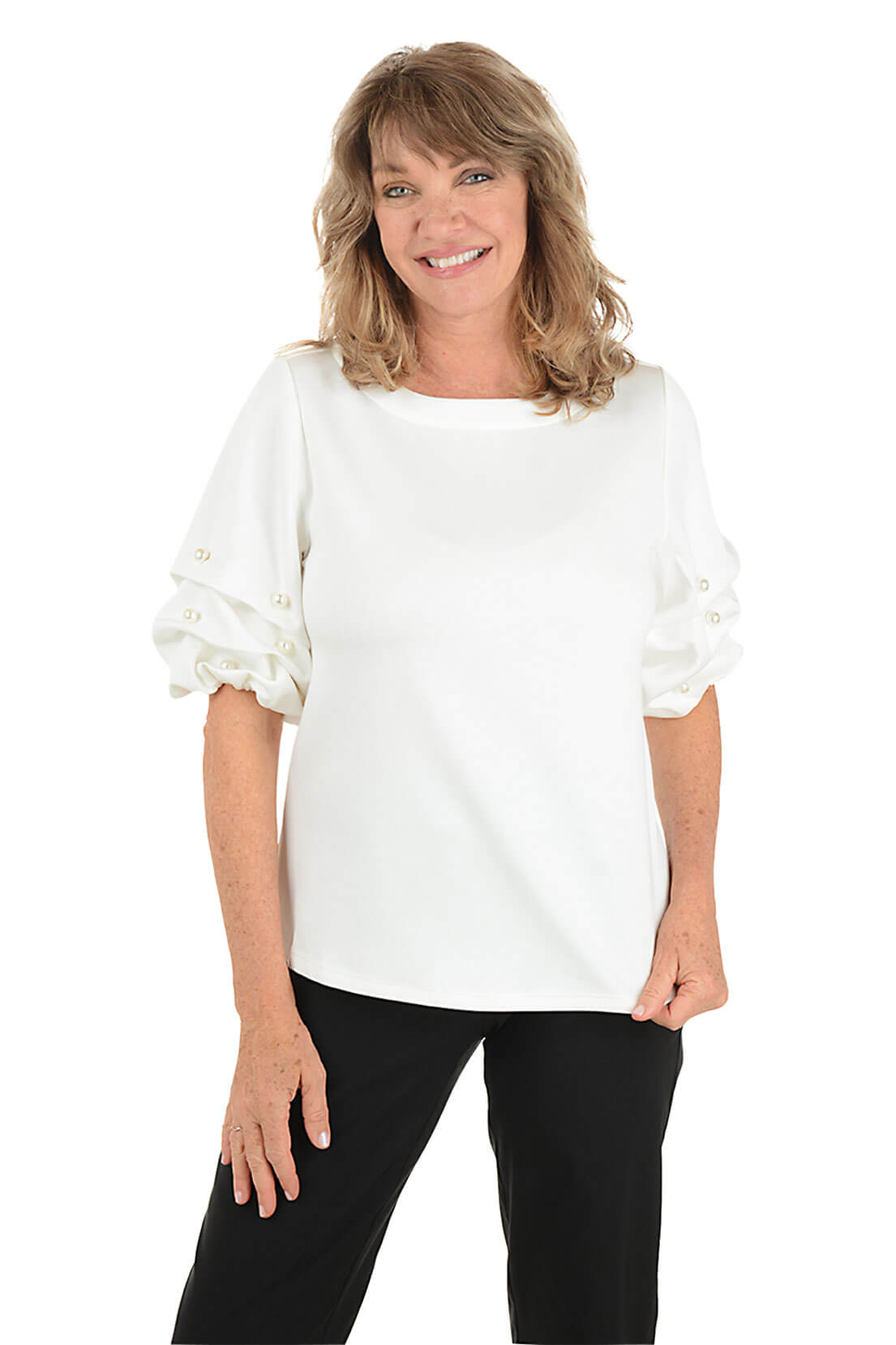 Woman wearing a white blouse with ruffled sleeves on a white background