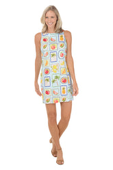 Woman wearing a sleeveless dress with fruit pattern on a white background
