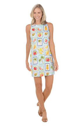 Woman wearing a sleeveless dress with fruit pattern on a white background
