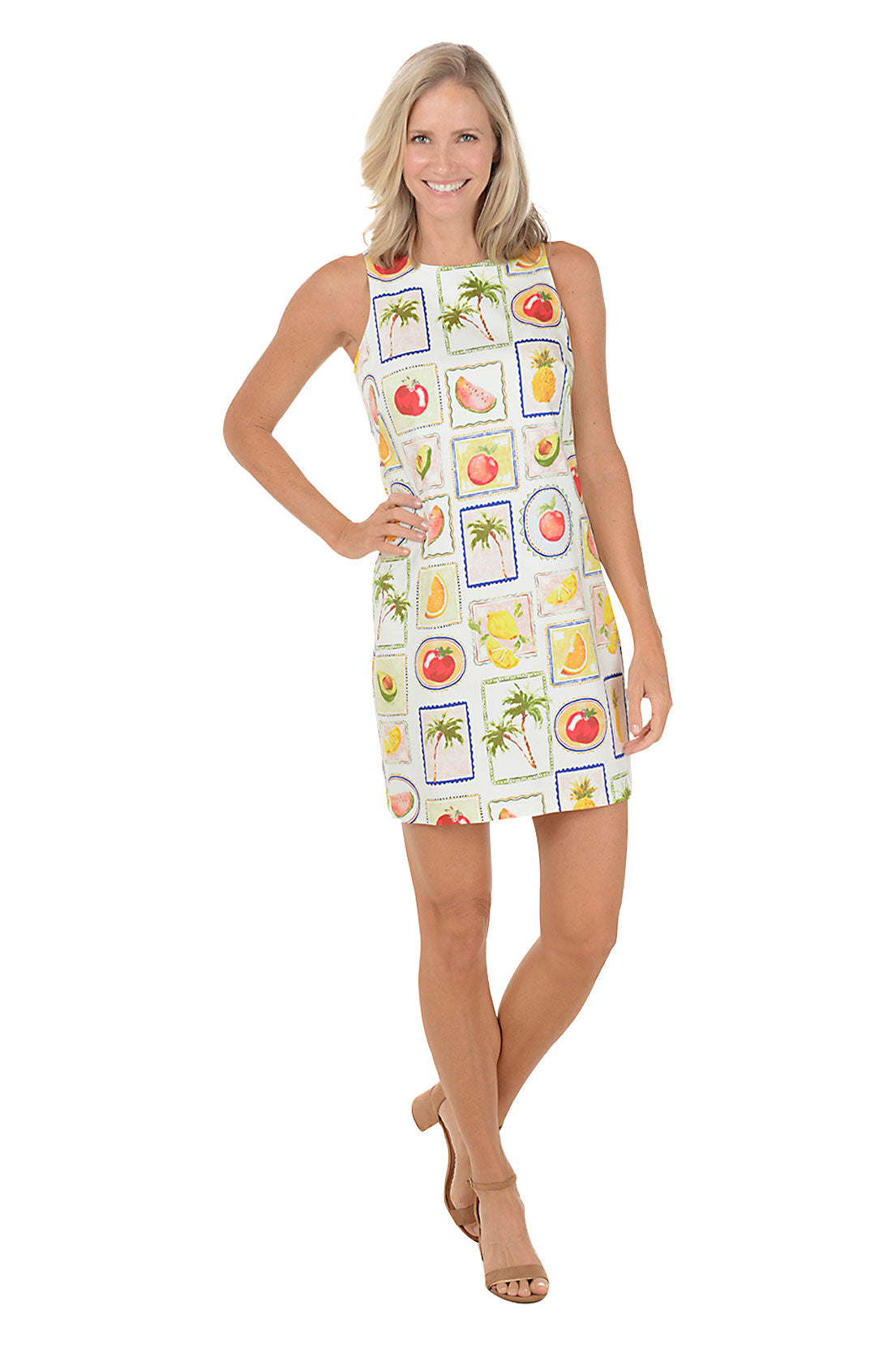 Woman wearing a sleeveless dress with fruit pattern on a white background