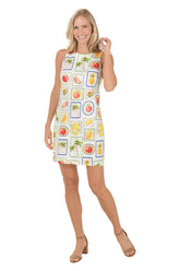 Woman wearing a sleeveless dress with fruit pattern on a white background